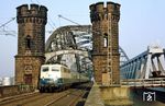 110 402-5 vom Bw Dortmund 1 mit E 2940 (Walkenried – Northeim/Han – Altenbeken – Hamm/Westf – Essen – Düsseldorf – Aachen) auf der alten Rheinbrücke zwischen Düsseldorf und Neuss. (06.03.1987) <i>Foto: Wolfgang Bügel</i>