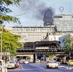 Blick über die Kantstraße am Bahnhof Zoo auf die mit D 336 nach Hamburg ausfahrende 01 0517. Im Hintergrund ist der Turm der Kaiser-Wilhelm-Gedächtniskirche und das Europacenter in der West-City zu sehen, davor das Schimmelpfeng-Haus, das 2013 abgerissen wurde. (1975) <i>Foto: Karsten Risch</i>